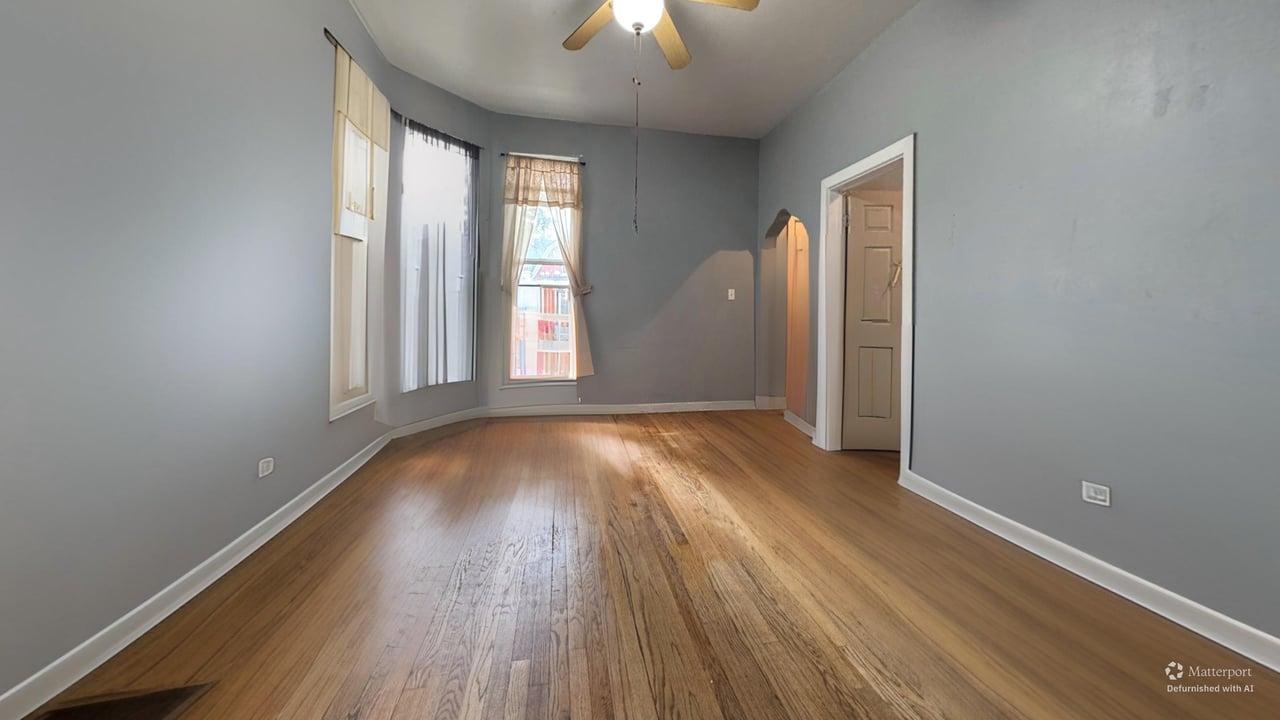1041 North Ridgeway Avenue Chicago, IL 60651 - Photo 4 of 33 an empty room with wooden floor and windows