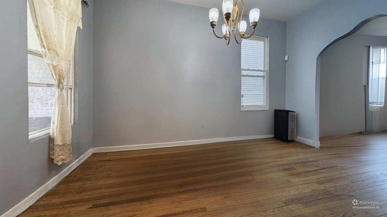 1041 North Ridgeway Avenue Chicago, IL 60651 - Photo 10 of 33 an empty room with wooden floor chandelier and windows