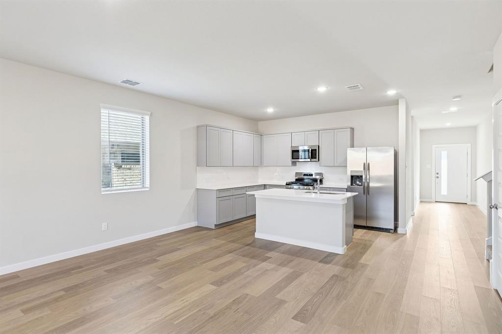 1156 Del Rio Drive Lavon, TX 75166 - Photo 11 of 35 a large kitchen with a lot of counter top space and stainless steel appliances