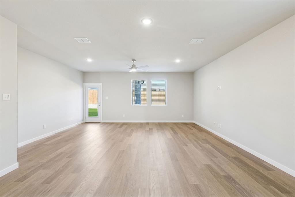 1156 Del Rio Drive Lavon, TX 75166 - Photo 13 of 35 an empty room with wooden floor and windows