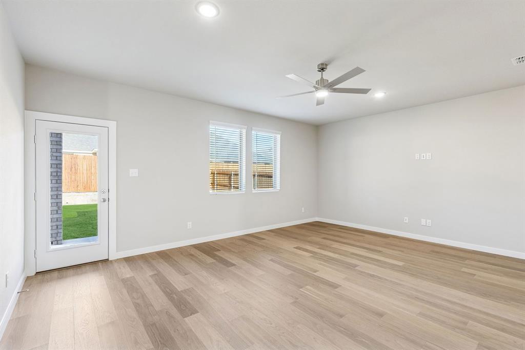 1156 Del Rio Drive Lavon, TX 75166 - Photo 14 of 35 wooden floor in an empty room with a window