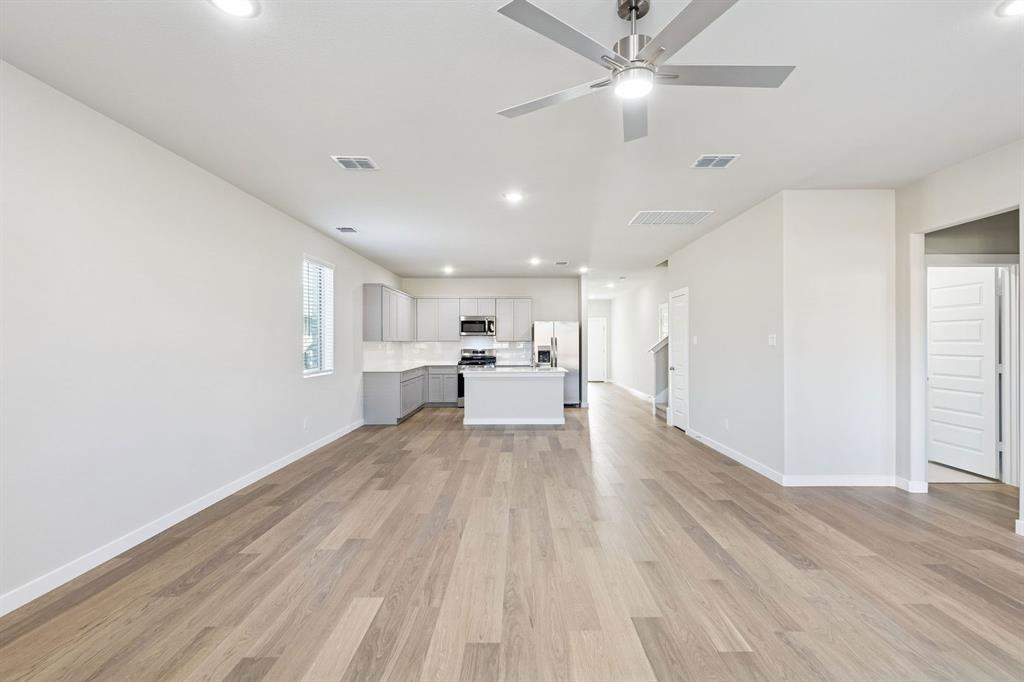 1156 Del Rio Drive Lavon, TX 75166 - Photo 18 of 35 a view of kitchen and empty room with wooden floor