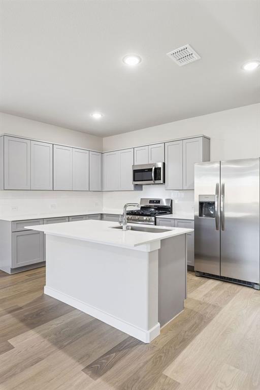 1156 Del Rio Drive Lavon, TX 75166 - Photo 10 of 35 a kitchen with stainless steel appliances a refrigerator stove and white cabinets