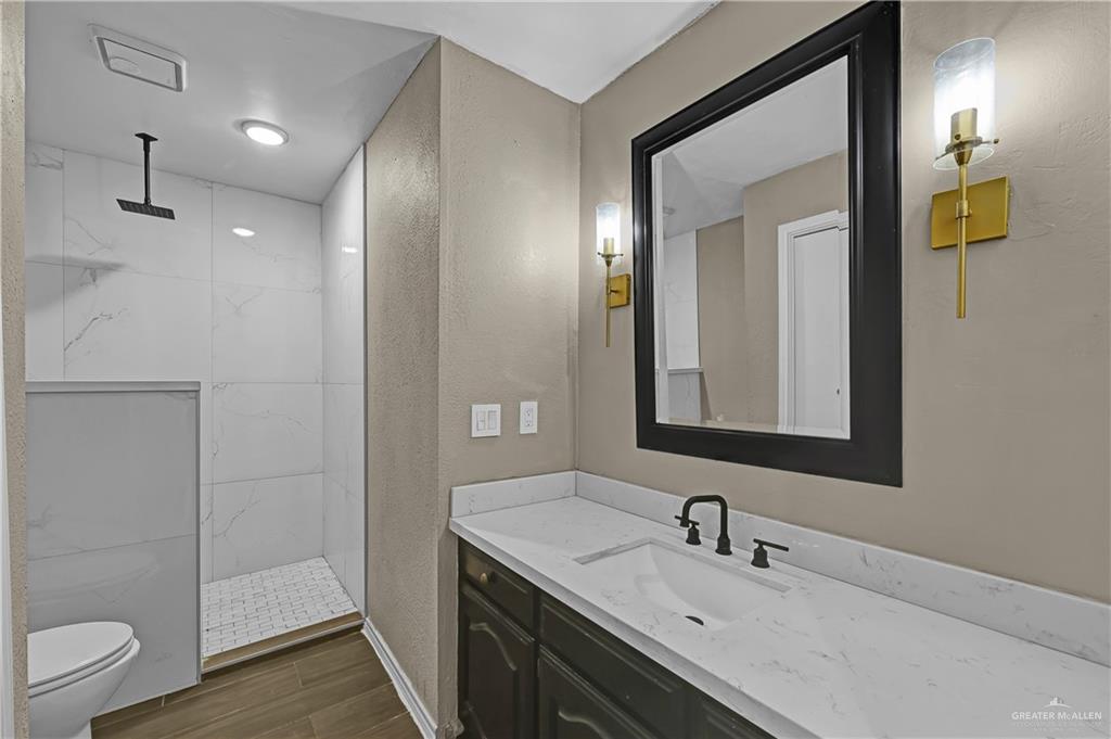 2401 South Jackson Road, Unit 29 Pharr, TX 78577 - Photo 12 of 20 a bathroom with a sink a toilet and shower