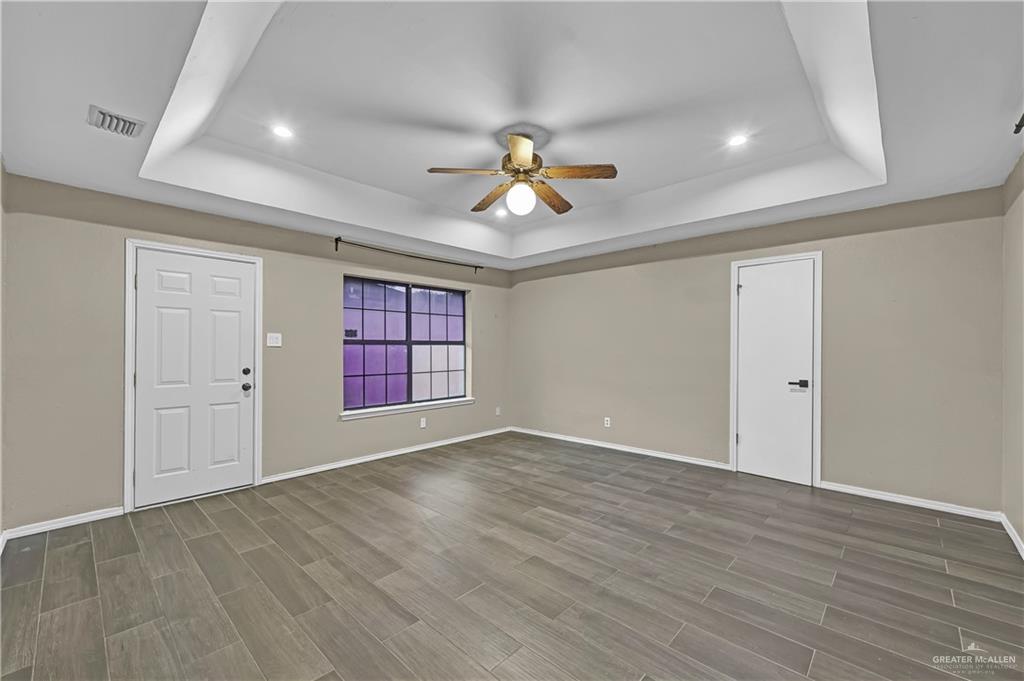 2401 South Jackson Road, Unit 29 Pharr, TX 78577 - Photo 13 of 20 wooden floor in an empty room with a window
