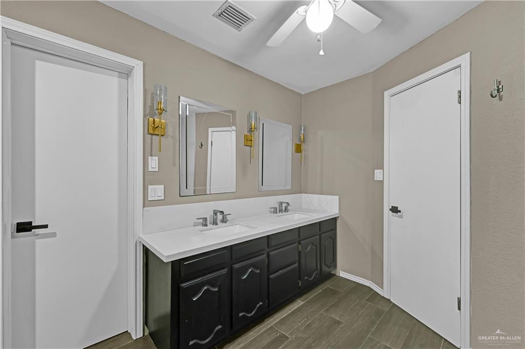 2401 South Jackson Road, Unit 29 Pharr, TX 78577 - Photo 14 of 20 a spacious bathroom with a double vanity sink and a mirror