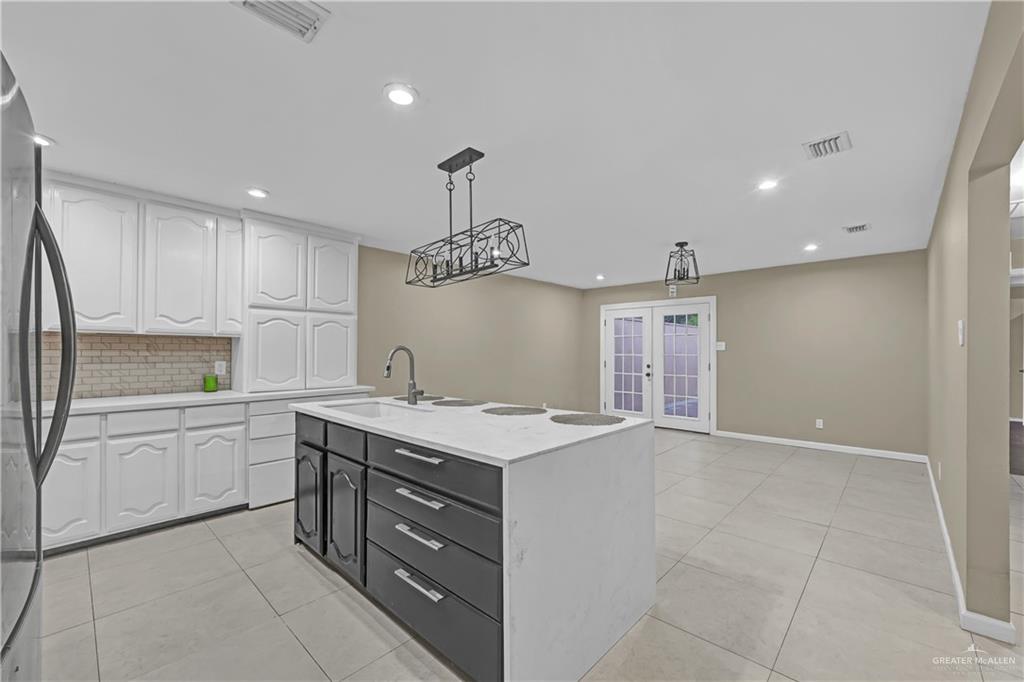 2401 South Jackson Road, Unit 29 Pharr, TX 78577 - Photo 4 of 20 a kitchen that has a lot of cabinets in it and wooden floors