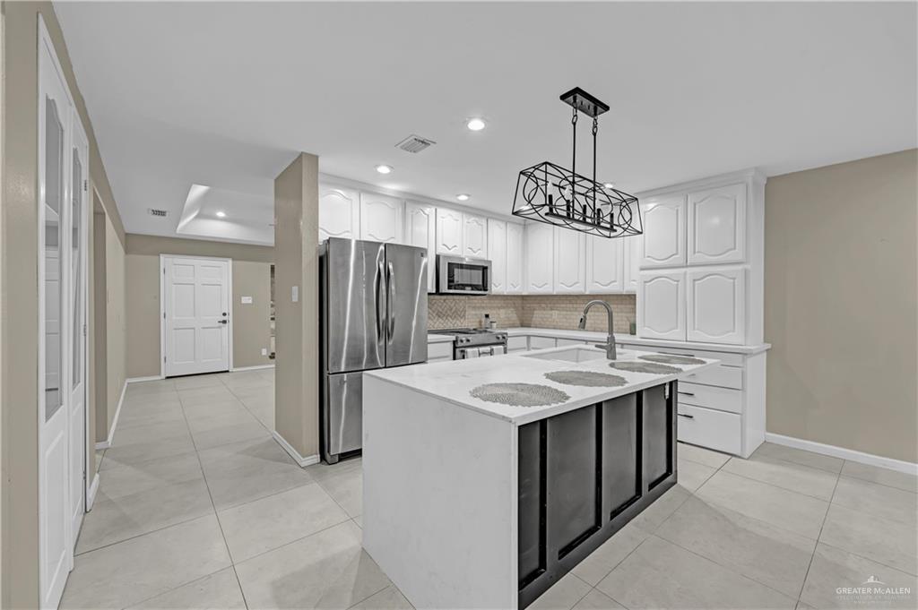 2401 South Jackson Road, Unit 29 Pharr, TX 78577 - Photo 5 of 20 a kitchen that has a sink a refrigerator and a stove top oven