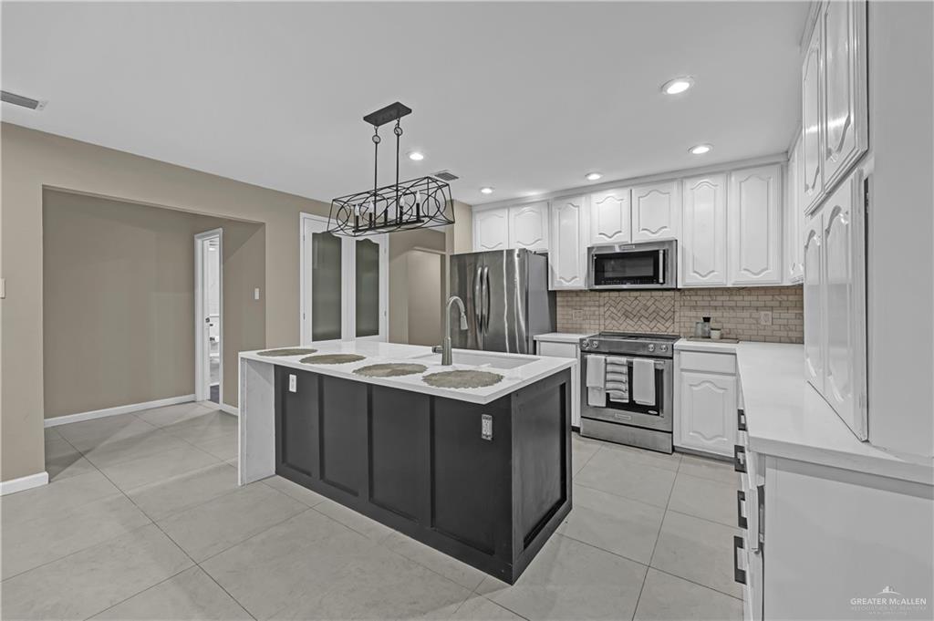 2401 South Jackson Road, Unit 29 Pharr, TX 78577 - Photo 6 of 20 a kitchen with a stove a sink and a refrigerator