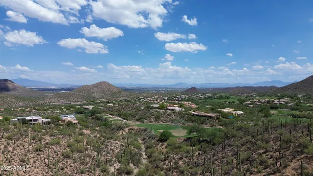 a view of a city with lots of residential buildings and mountain view in back