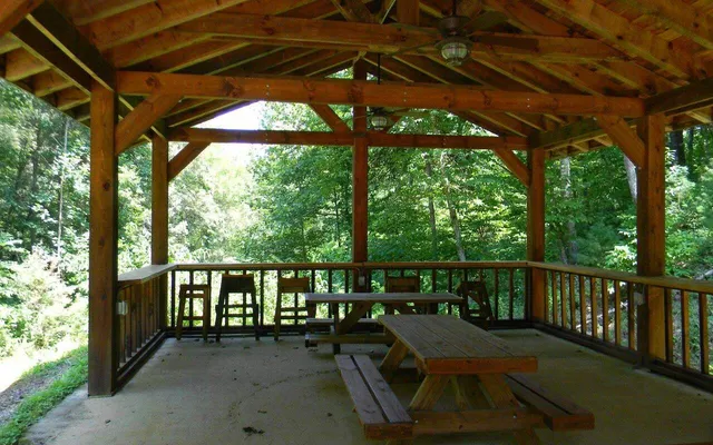 a view of a patio with a table chairs and a backyard