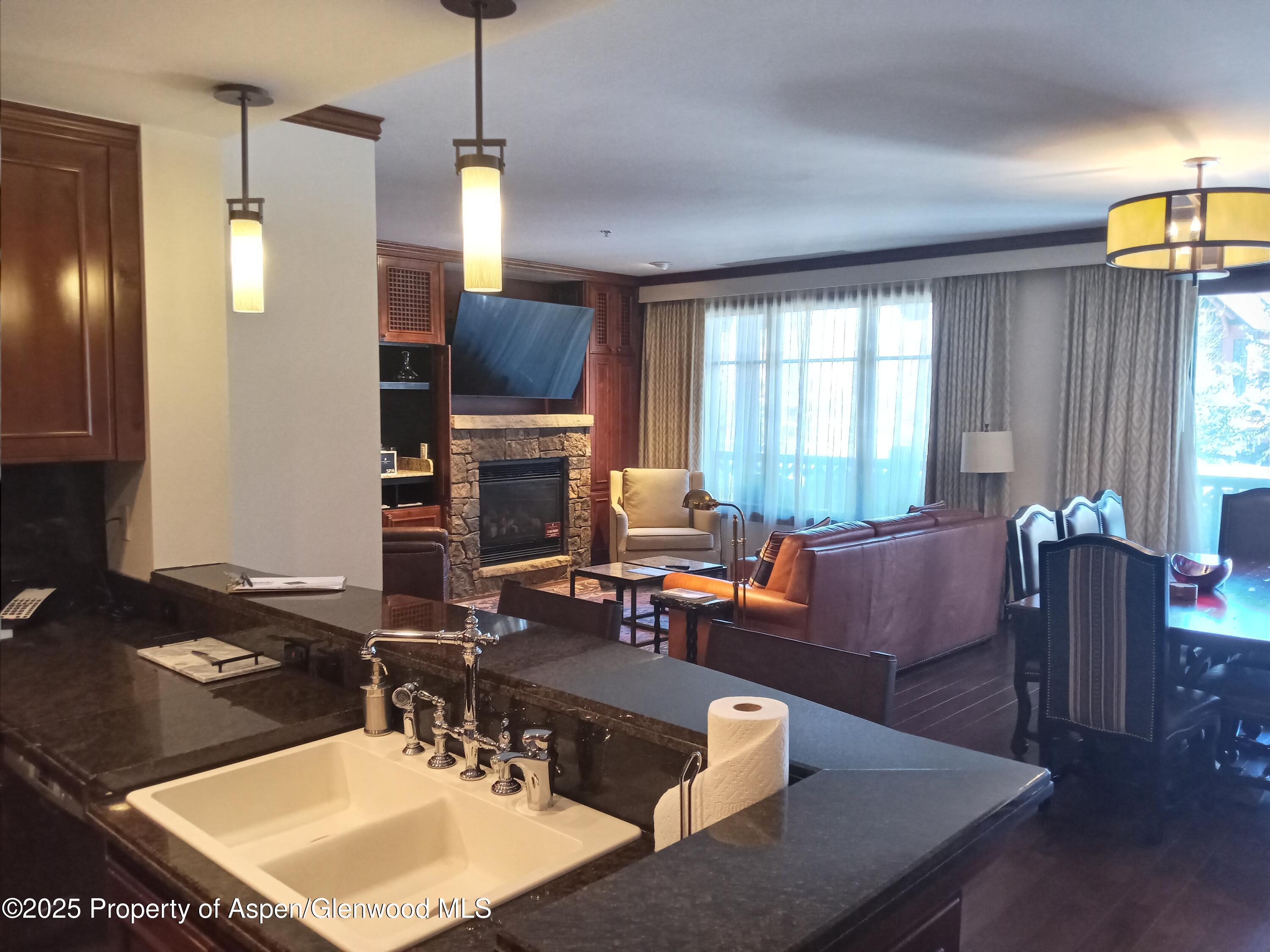 197 Prospector Road, Unit 2312 FIXED WEEKS 1 34 35 Aspen, CO 81611 - Photo 31 of 38 a living room with furniture a window and a flat screen tv