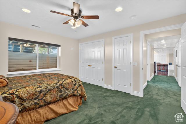4768 East Hickman Canyon Road Stockton, UT 84071 - Photo 51 of 85 Basememnt bedroom with dark colored carpet, multiple closets, recessed lighting, and a ceiling fan.