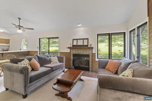 a living room with furniture and a fireplace