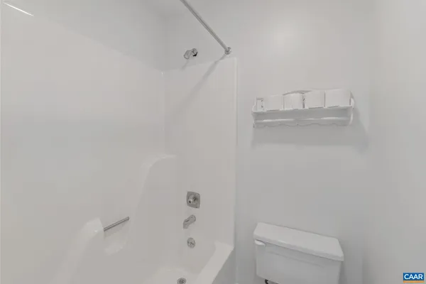 a bathroom with a toilet and a bathtub