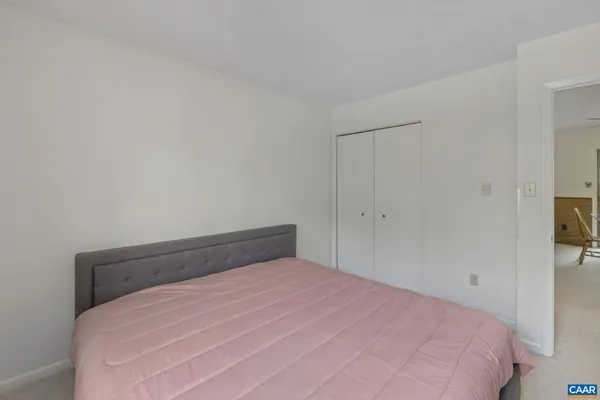 a bedroom with a bed and a tv