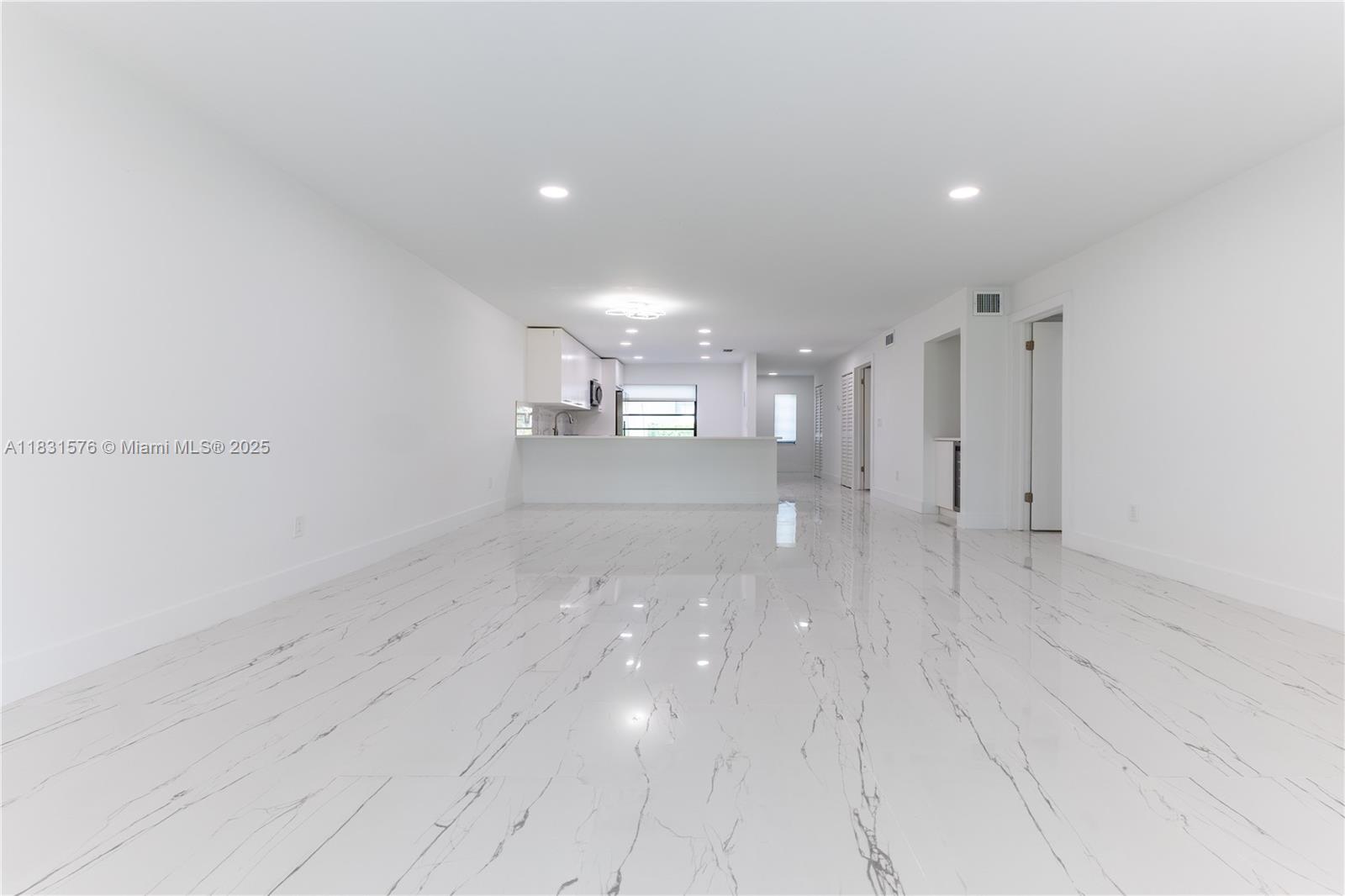 8435 Casa Del Lago, Unit 22C Boca Raton, FL 33433 - Photo 12 of 55 a view of empty room with wooden floor