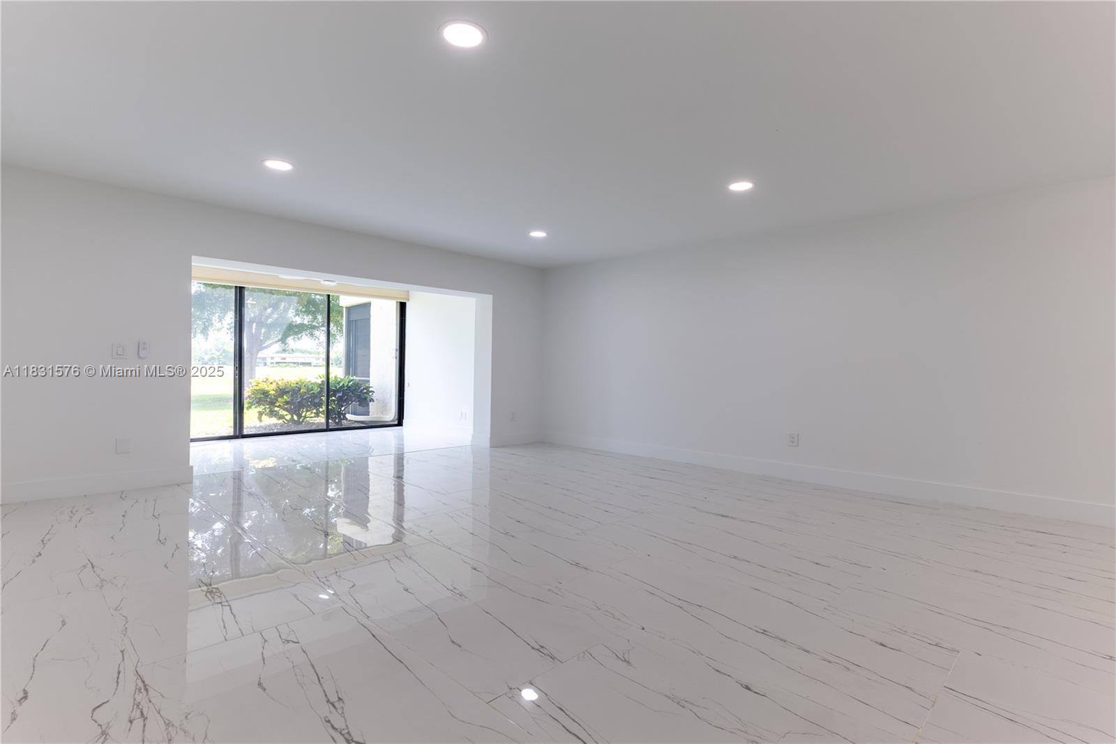8435 Casa Del Lago, Unit 22C Boca Raton, FL 33433 - Photo 14 of 55 an empty room with wooden floor and windows