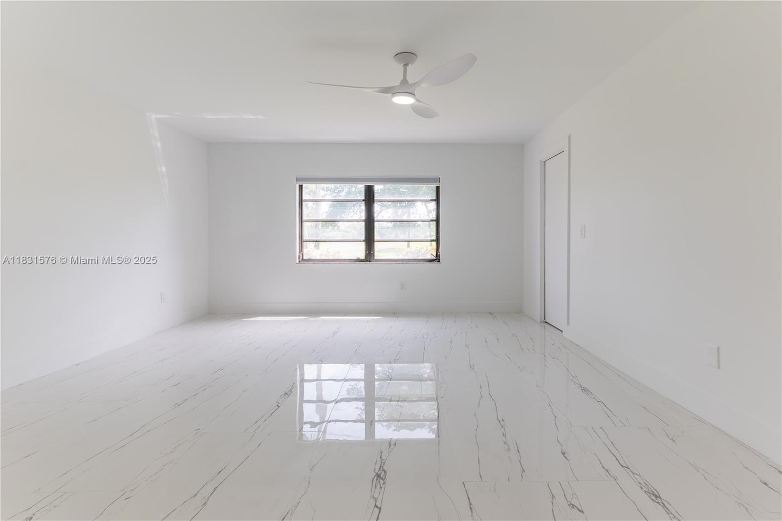 8435 Casa Del Lago, Unit 22C Boca Raton, FL 33433 - Photo 23 of 55 an empty room with windows and closet