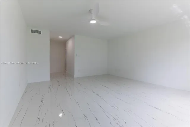a room with white cabinets and window