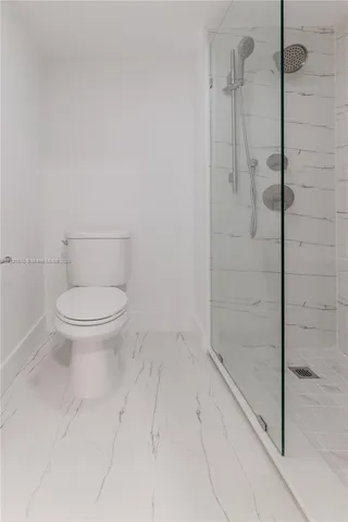 a bathroom with a toilet a sink a mirror and vanity