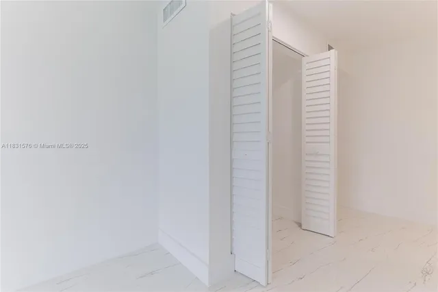 a bedroom with two beds and painted walls