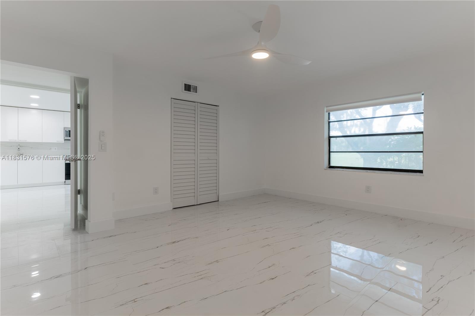 8435 Casa Del Lago, Unit 22C Boca Raton, FL 33433 - Photo 36 of 55 wooden floor in an empty room with a window