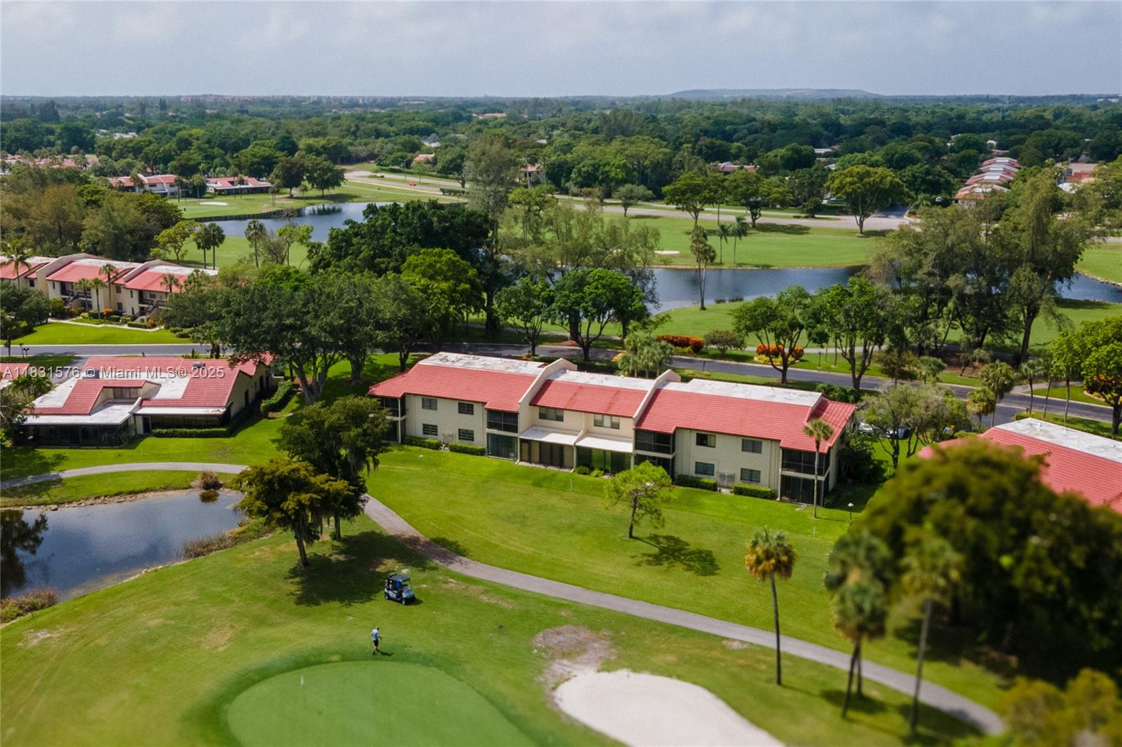 8435 Casa Del Lago, Unit 22C Boca Raton, FL 33433 - Photo 50 of 55 an aerial view of a houses with a garden and lake view