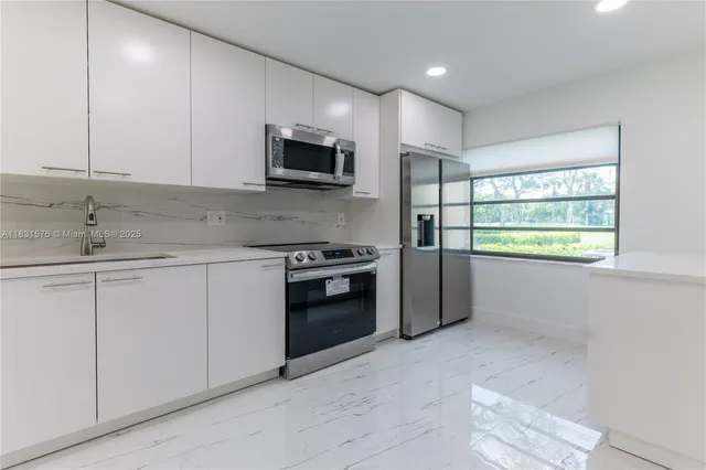 a kitchen with wooden cabinets and a stove top oven