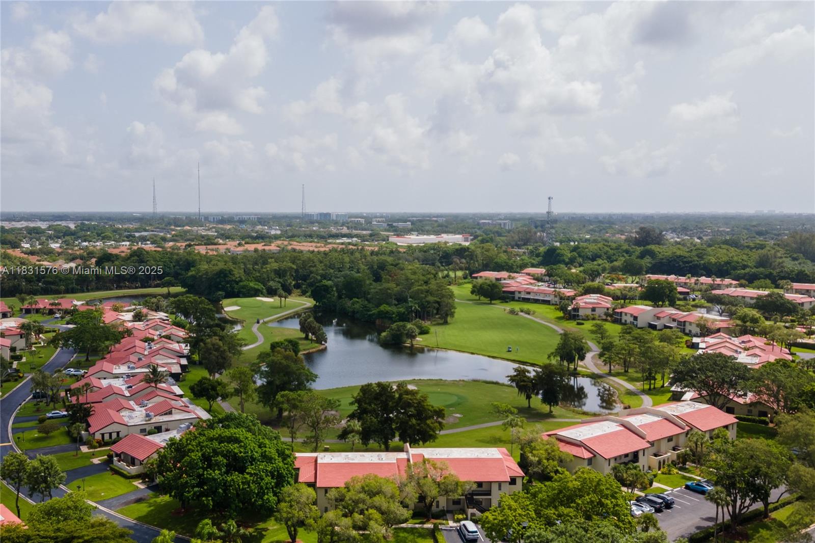 8435 Casa Del Lago, Unit 22C Boca Raton, FL 33433 - Photo 53 of 55 an aerial view of a city with lots of residential buildings ocean and mountain view in back
