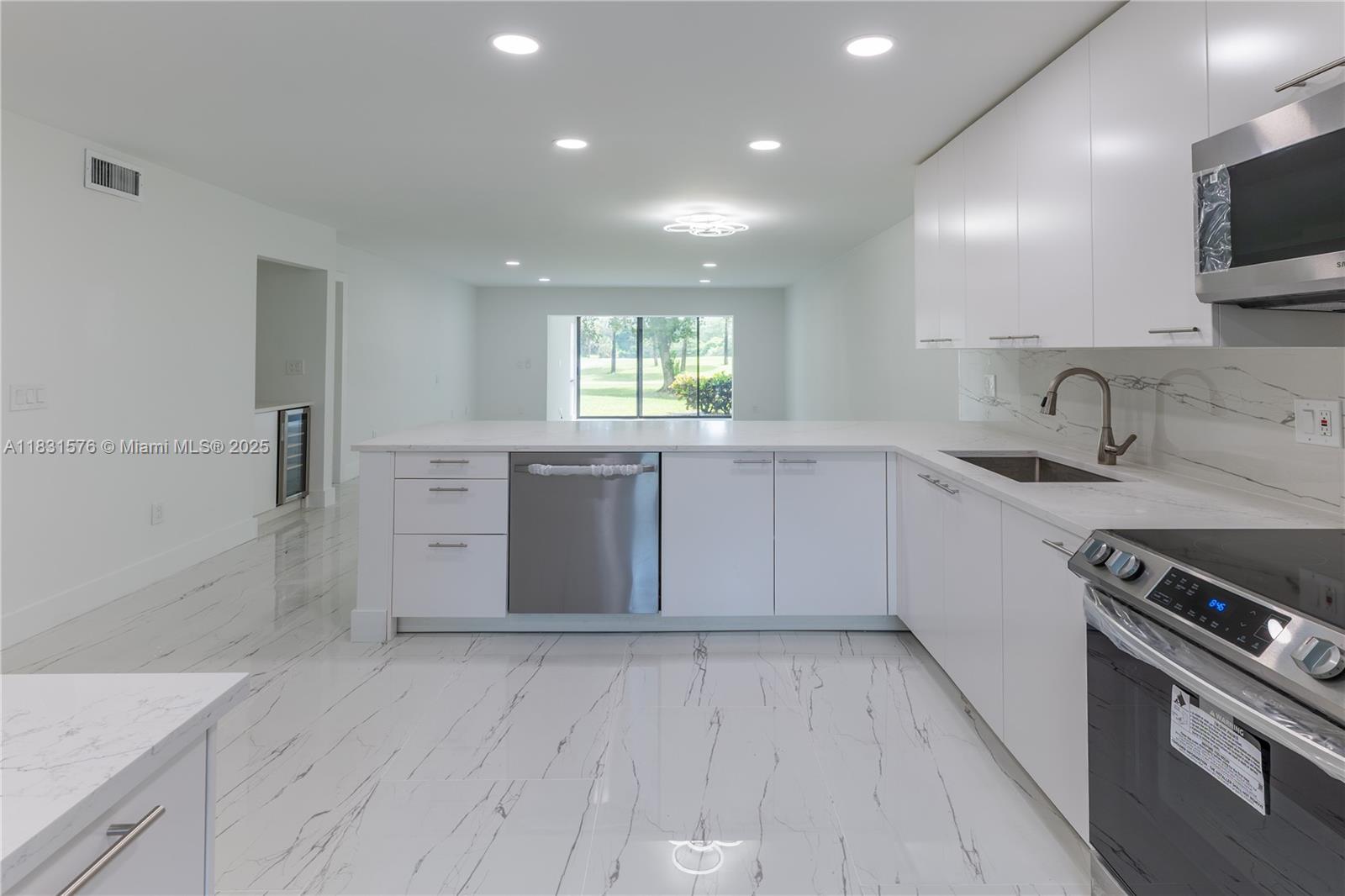8435 Casa Del Lago, Unit 22C Boca Raton, FL 33433 - Photo 8 of 55 a kitchen with a sink cabinets and window