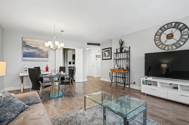 a view of a dining room with furniture wooden floor and a chandelier