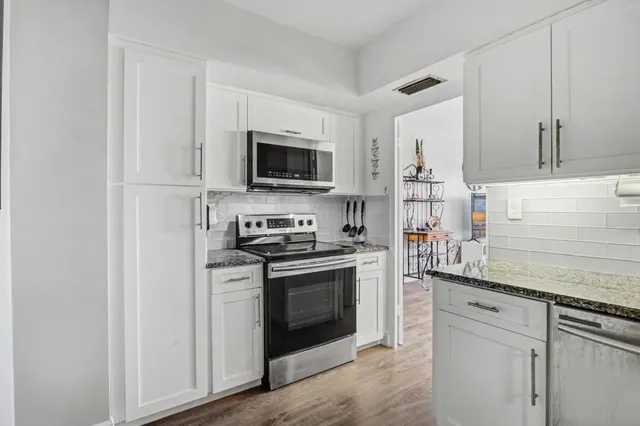 a view of a hallway to closet and utility room