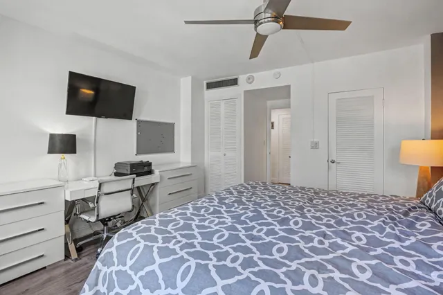 a bathroom with a granite countertop sink toilet and a mirror
