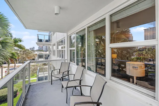 a view of a room that has a window and wooden floor