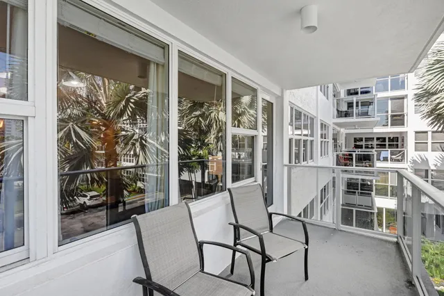 a row of palm trees in front of a house