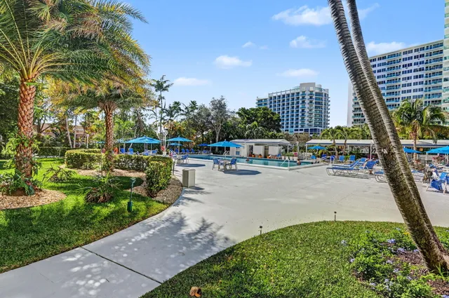 a room with lots of chairs a tables and a rug