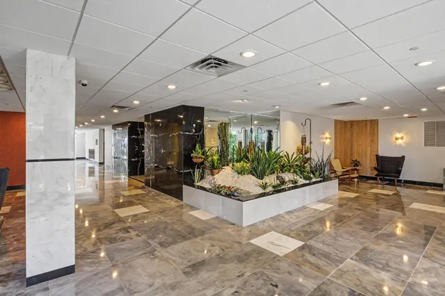 a view of a lobby with black carpet