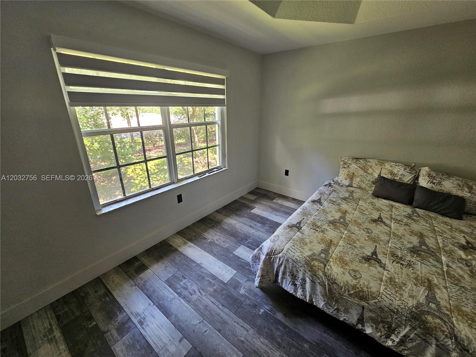 4331 Southwest 124th Way Miramar, FL 33027 - Photo 10 of 40 a bed sitting in a bedroom next to a window