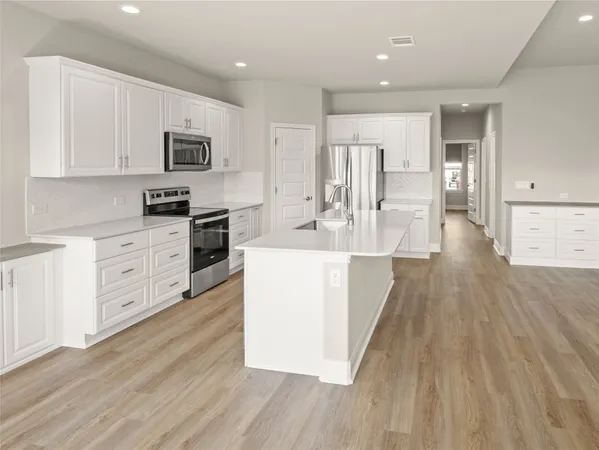 a view of kitchen with sink and wooden floor