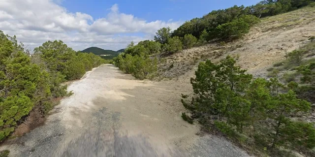 a view of a pathway with a yard