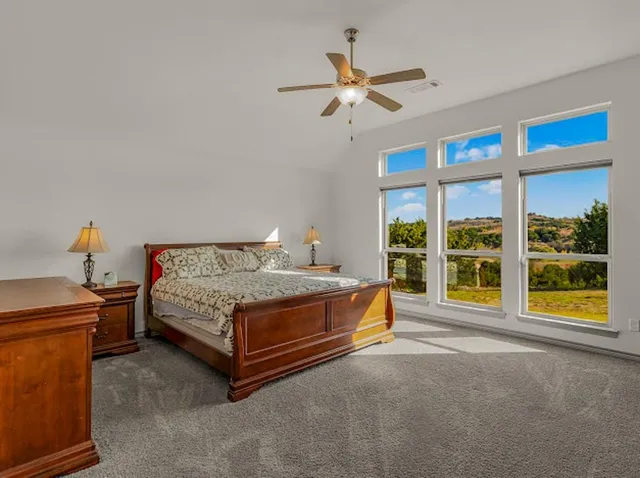 a spacious bathroom with a granite countertop sink and a mirror