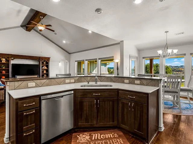a kitchen with stainless steel appliances granite countertop a refrigerator stove and sink