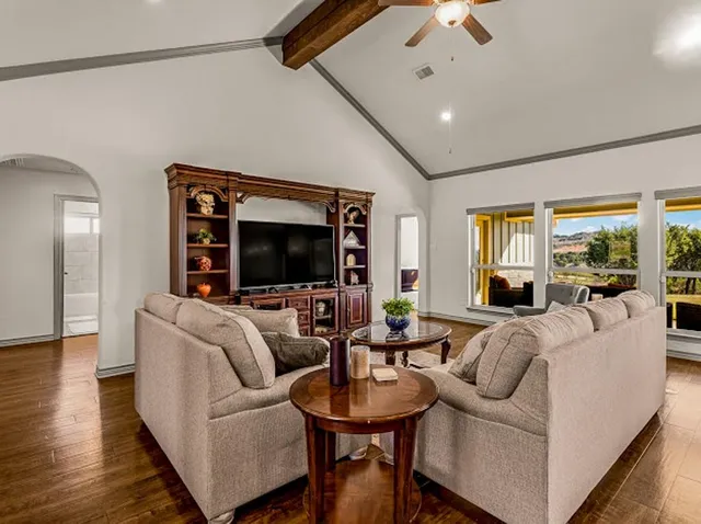 a bedroom with a bed and a large window
