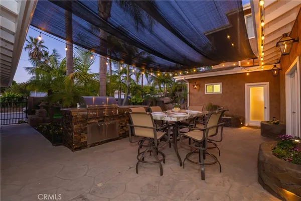a view of backyard with swimming pool and outdoor seating