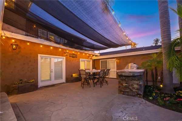 a spacious bathroom with a double vanity sink a large mirror and a bathtub