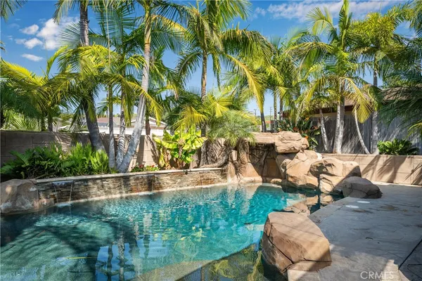 a kitchen with kitchen island wooden cabinets a sink and appliances