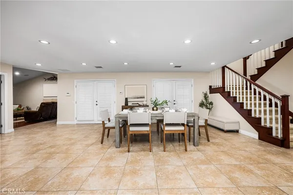 a view of a big room with wooden floor and stainless steel appliances