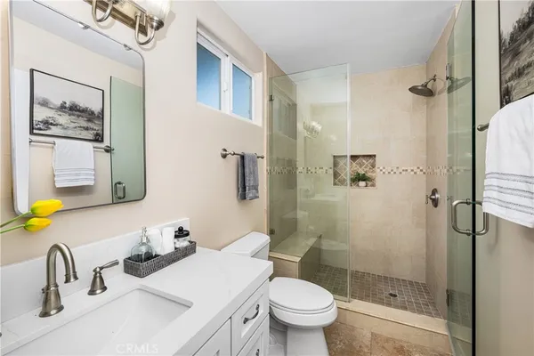 a view of a house with a yard and potted plants