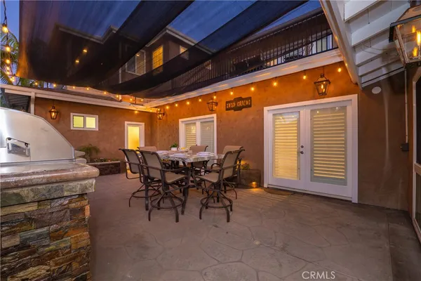 a view of a backyard with plants and palm tree